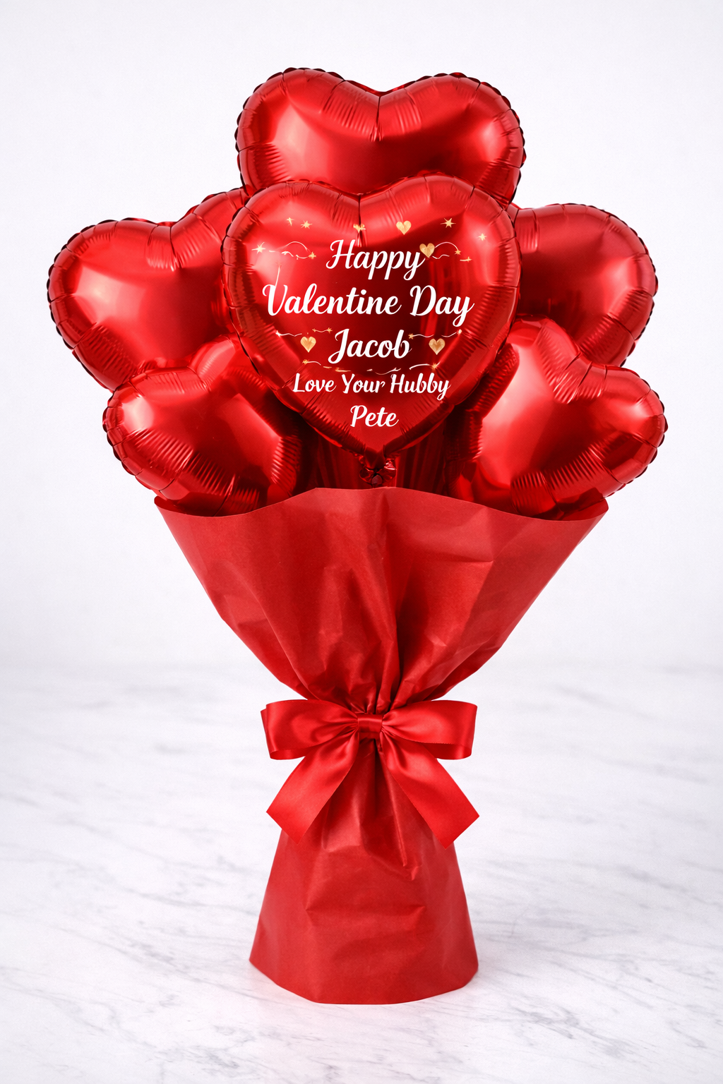 Red heart-shaped helium balloon bouquet with personalised message for Valentine’s Day surprises in Brisbane and Gold Coast